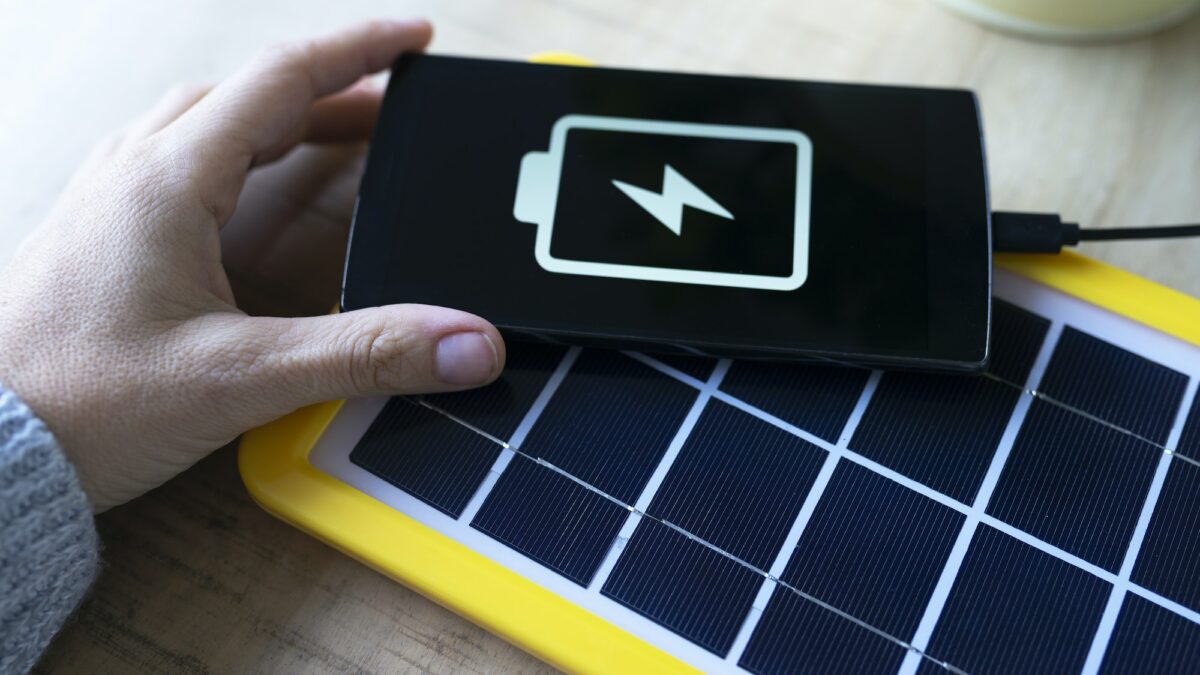 Renewable energy technology, solar panel charging a mobile phone battery