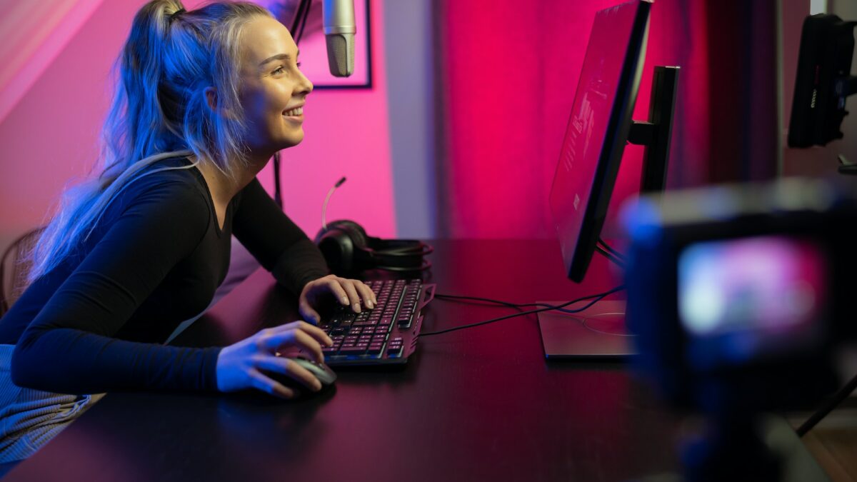 Professional esport gamer girl streaming vlog and plays online video game on PC