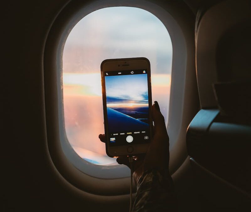 Person Holding Smartphone Inside Airplane