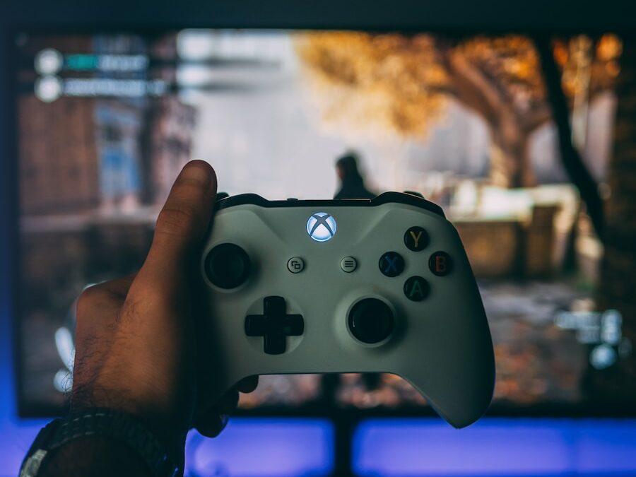 person holding white xbox one controller