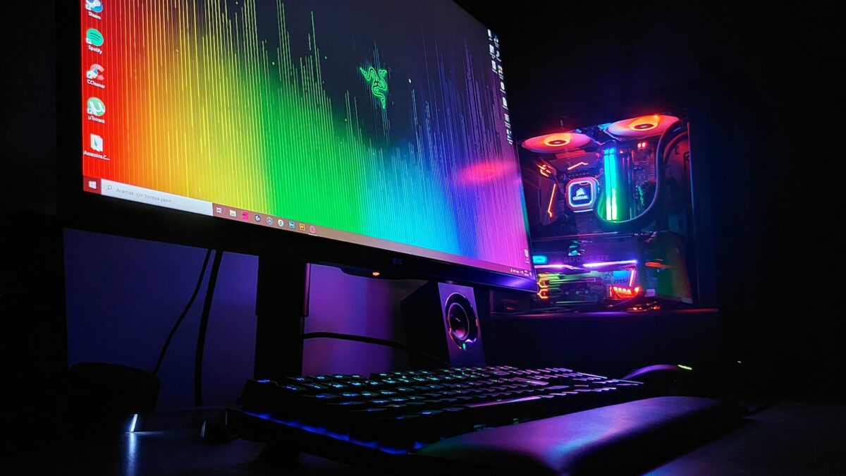 black flat screen computer monitor turned on beside black computer keyboard