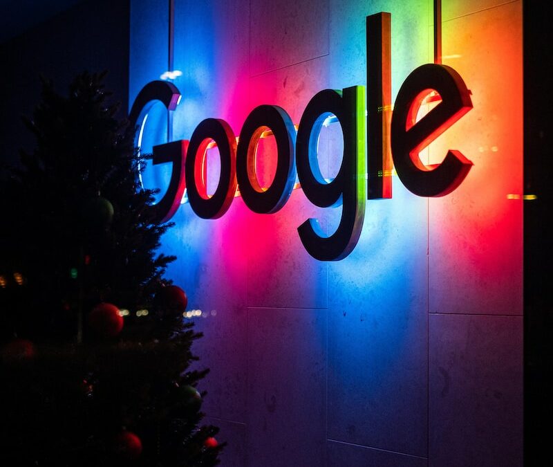 the google logo is lit up at night