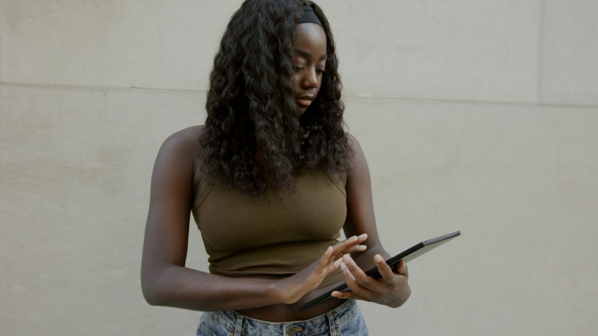 Female typing on her Surface laptop, with a blank wall in the background