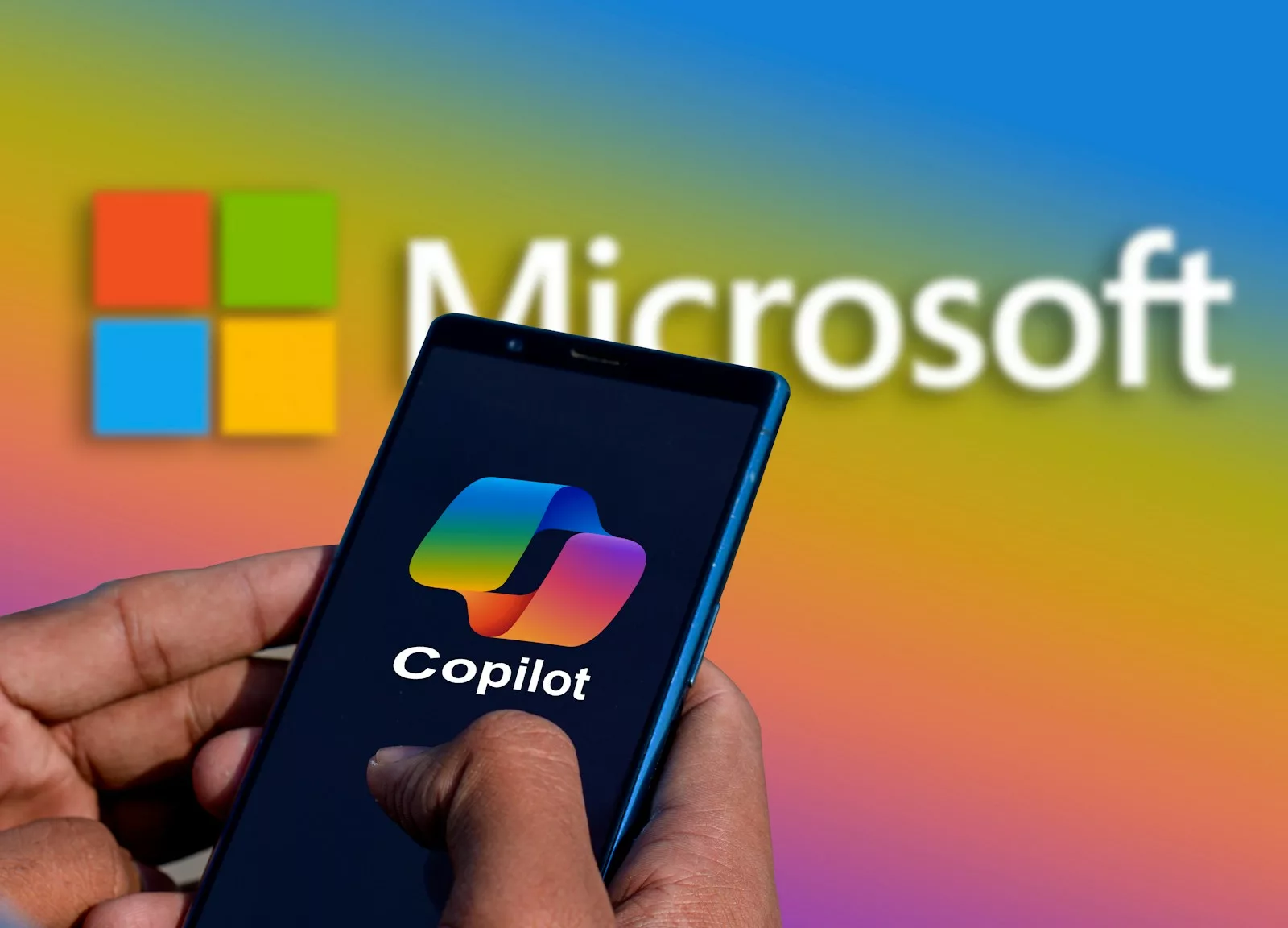 a person holding a cell phone in front of a microsoft copilot logo