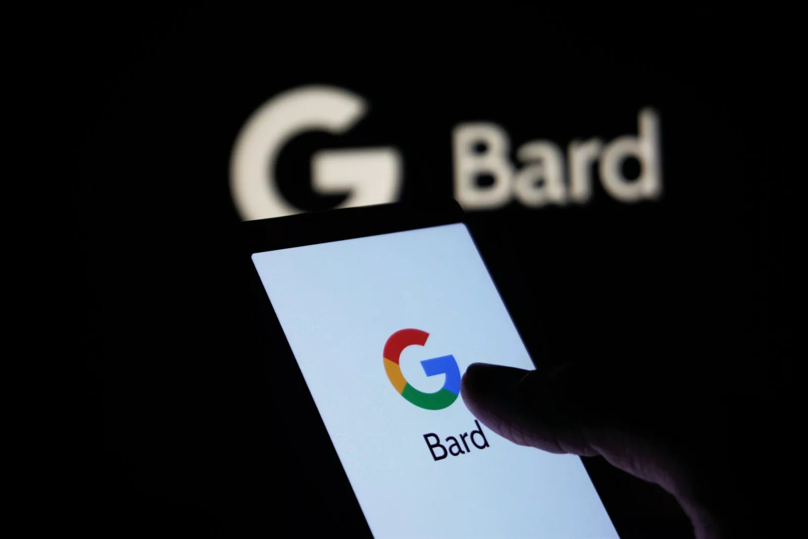 a person using a cell phone in front of a bard logo