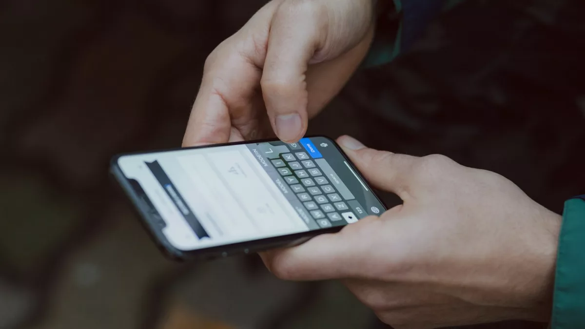 selective focus photography of person using smartphone
